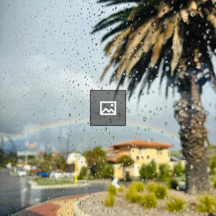 Water droplets on glass with rainbow