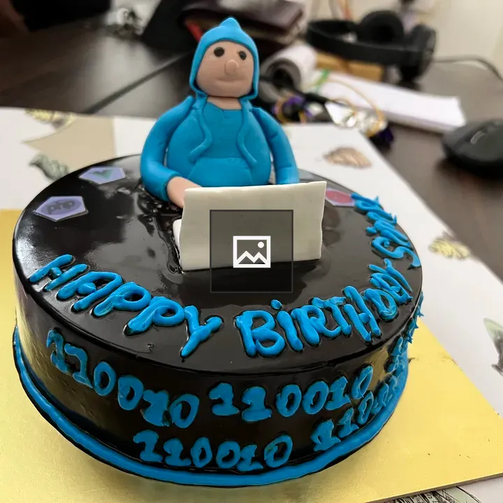 Chocolate birthday cake with laptop figurine