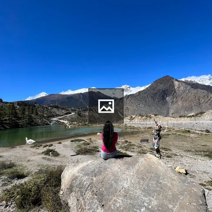 Young woman on rock by Dhumba Lake
