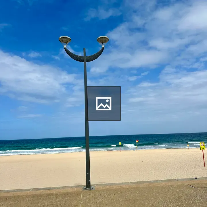 Smiley lamp post by the sea