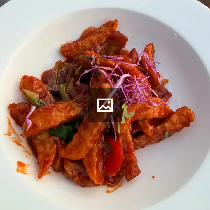 Bowl of red sauce-coated vegetable strips