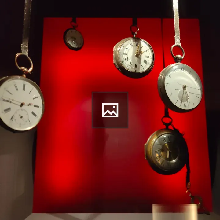 Pocket watches against red backdrop