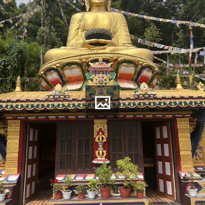 Seated Buddha Statue in Front of Temple