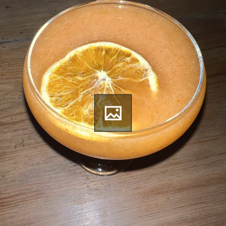 Orange cocktail in coupe glass