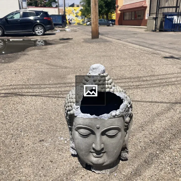 Broken Buddha Head in Alley