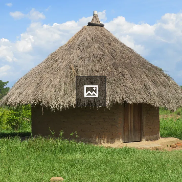 Circular mud-brick hut with thatched roof