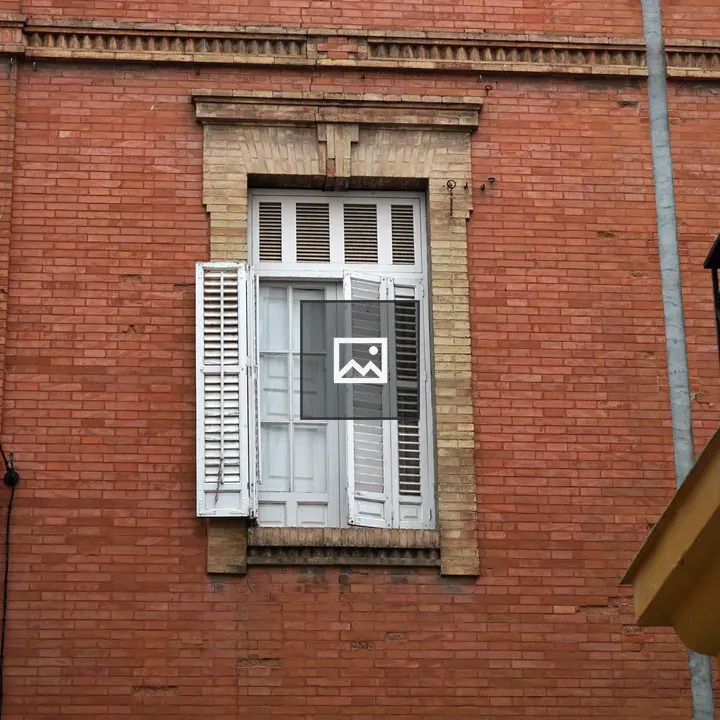 Red Brick Wall with White Window