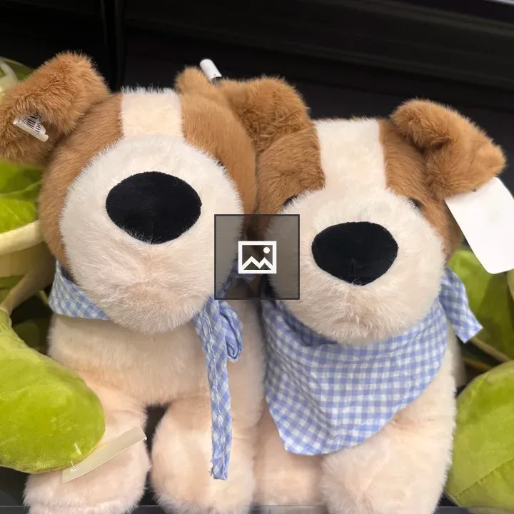 Two plush puppy toys with bandanas