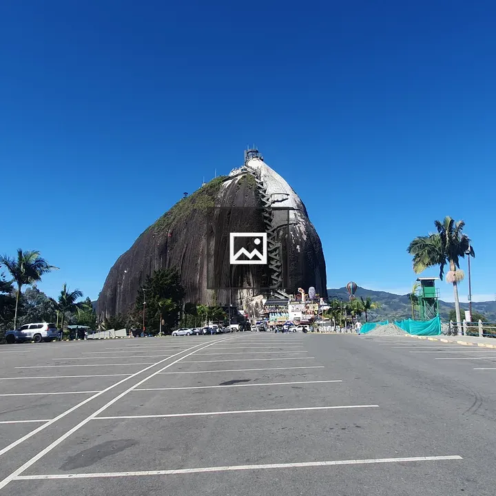 Rock formation with staircase and parking lot