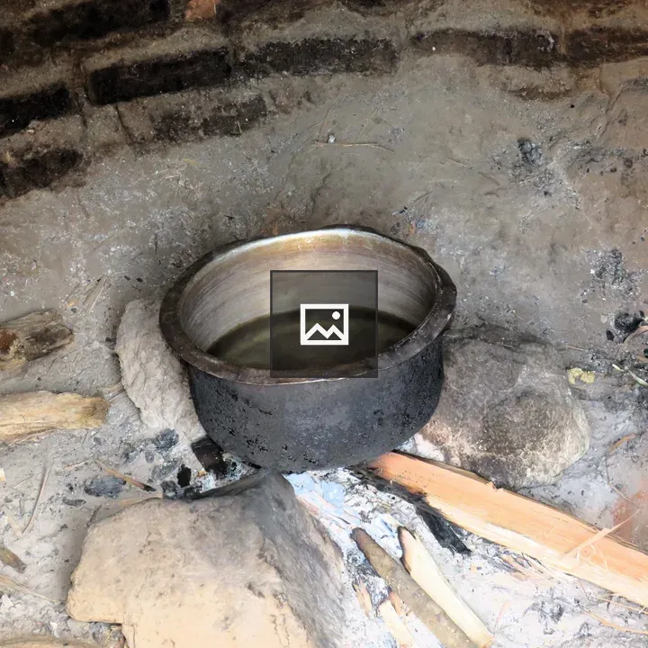 Pot over a wood fire in hut kitchen