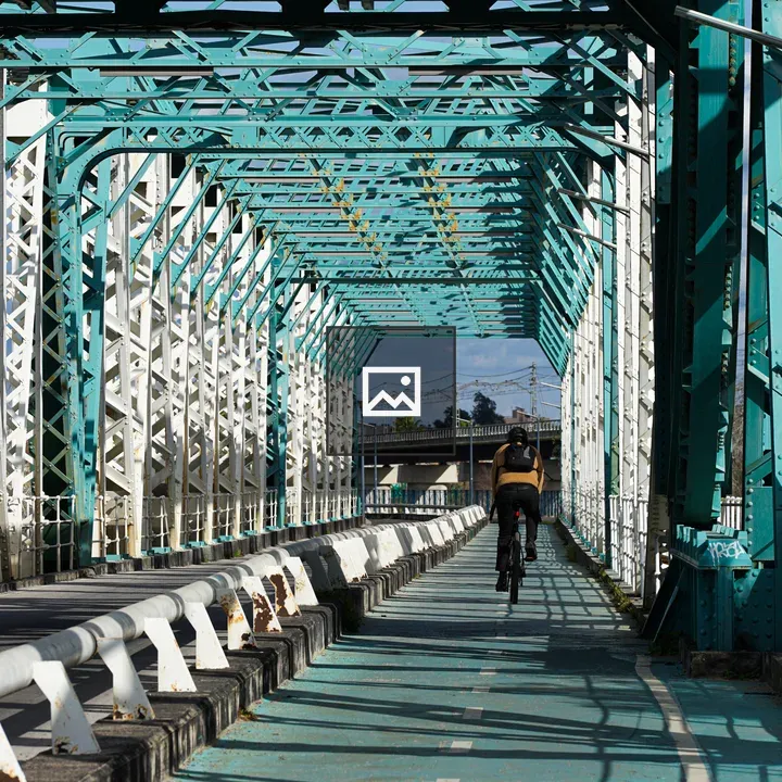 Man on bicycle on bridge line