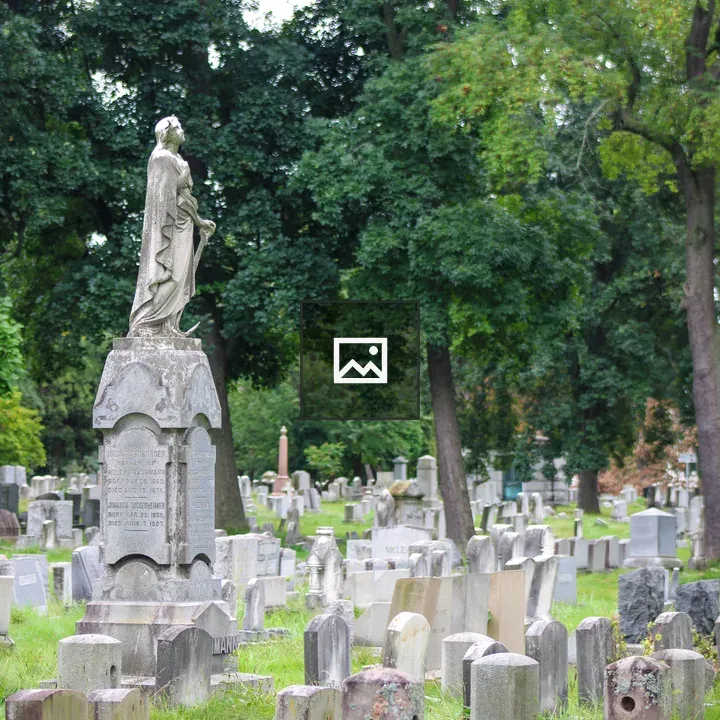 Statue atop gravestone at Mt. Hope Cemetery