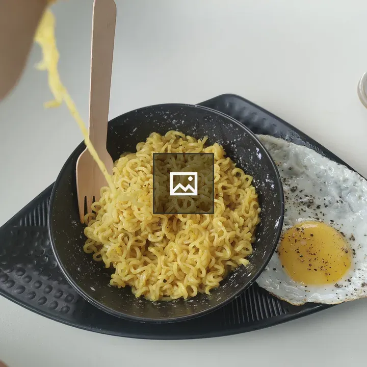 Bowl of instant noodles with fried egg