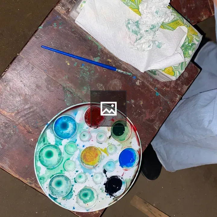 Palette with Brush on Wooden Table