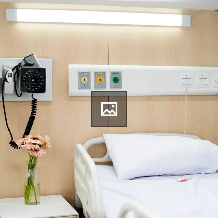 Hospital bed with flowers in room