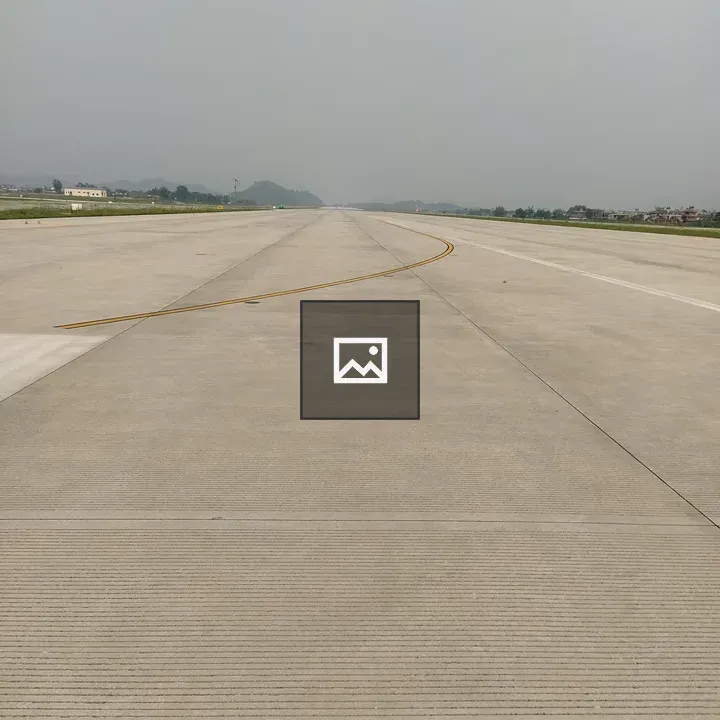 Airport runway with distant mountains
