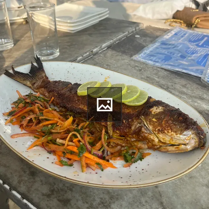 Fish served on plate with vegetables
