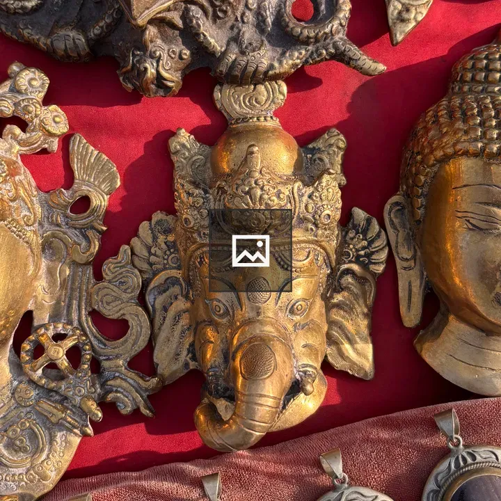 Brass Masks on Red Cloth