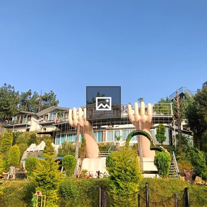 Hand sculptures on hillside resort