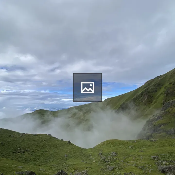 Green hills with mist and clouds