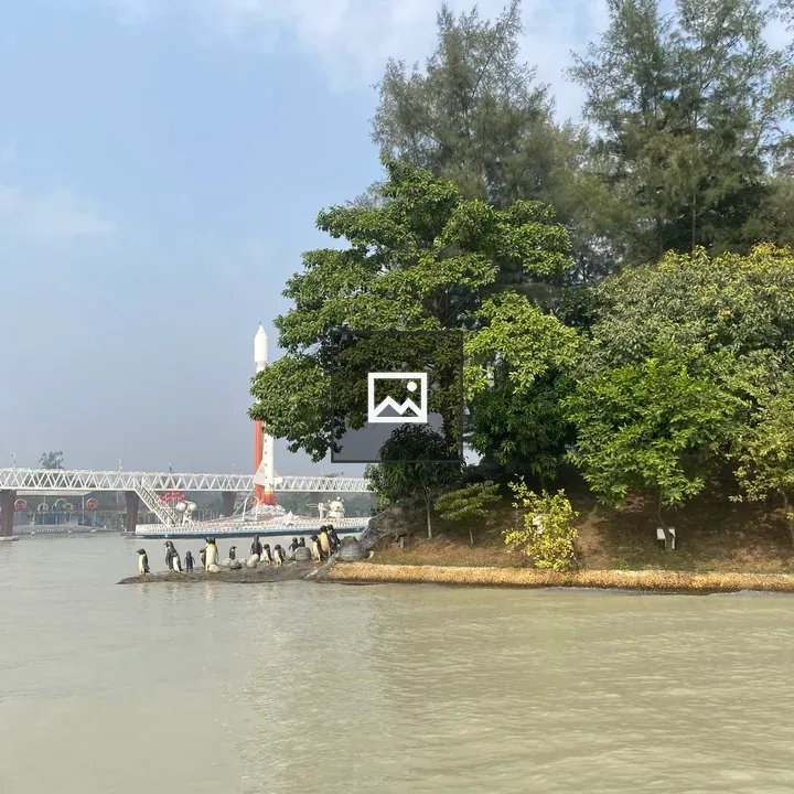 Riverside Trees and Penguin Statues