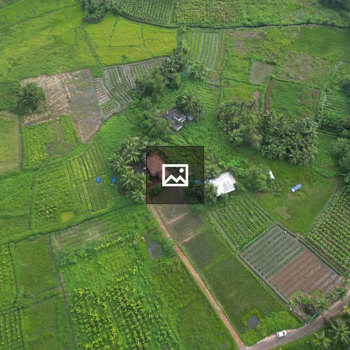 Aerial farmland with farmhouse