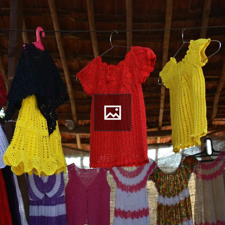 Colorful crocheted garments on bamboo frame