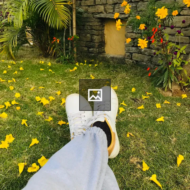 Legs in Sneakers on Petal Lawn