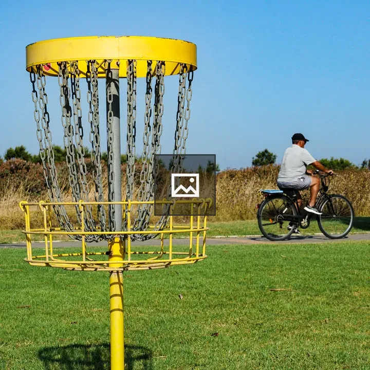 Yellow Disc Golf Basket in Field