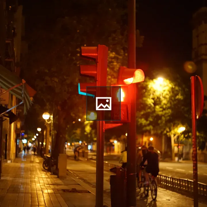 City street at night with red pedestrian signal