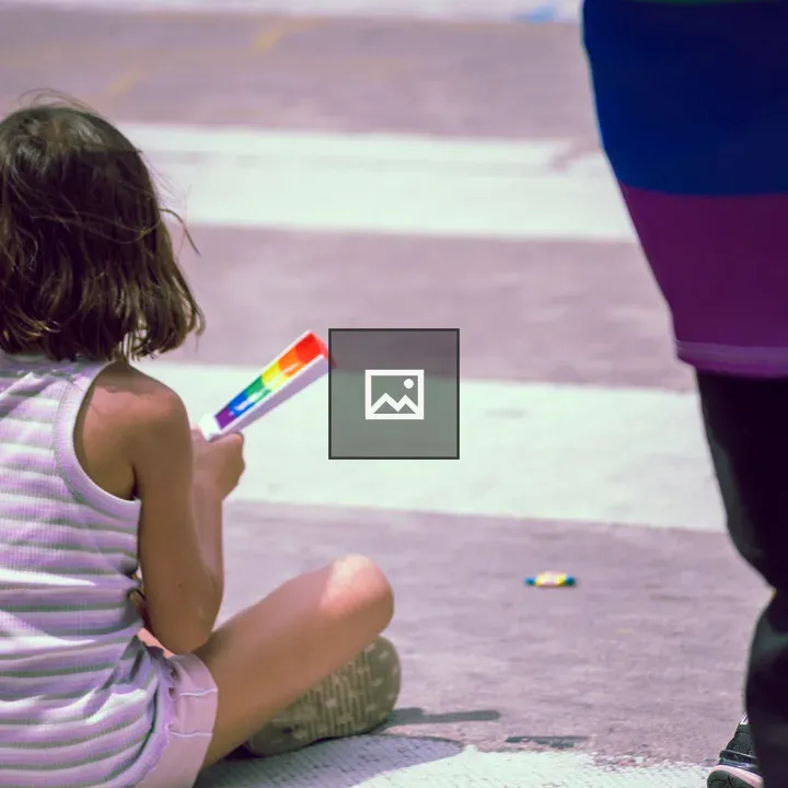 Child with Rainbow Flag at Pride Parade