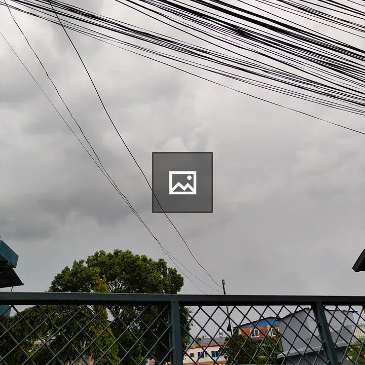 View of cloudy sky with wires