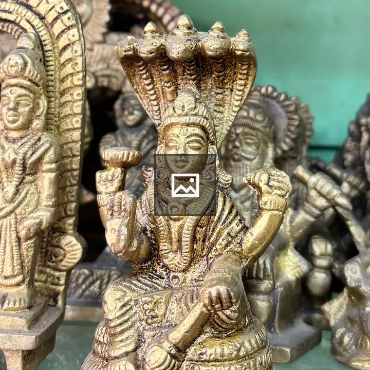 Brass statue of seated multi-armed deity