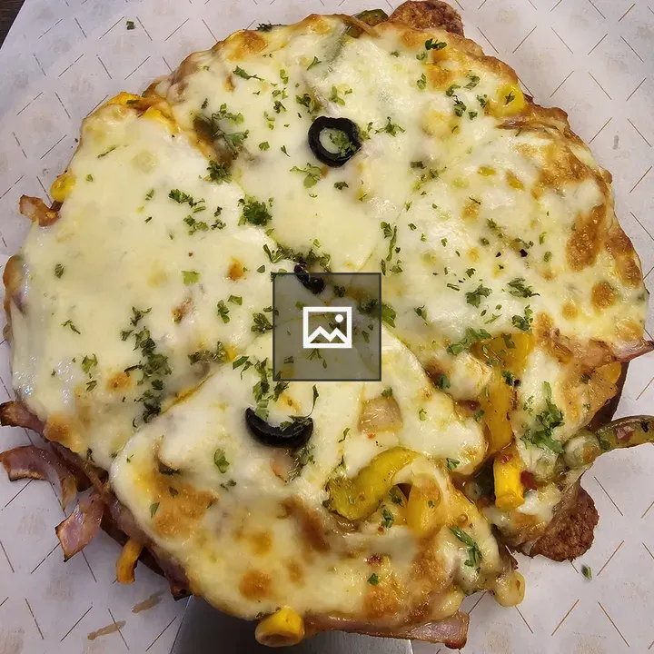 Pizza on Spatula with Toppings