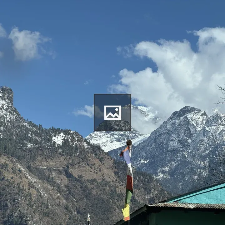 Snow capped mountains with flag on turquoise roof