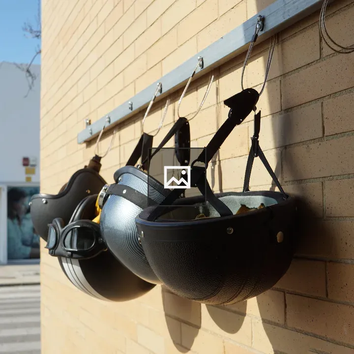 Four Motorcycle Helmets on Hooks