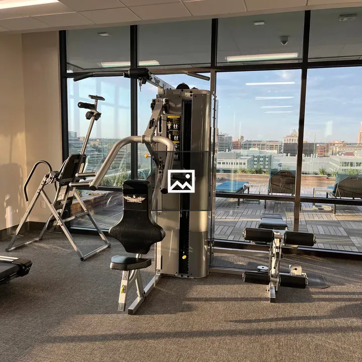 Bench press machine in gym with glass walls