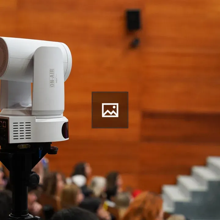 Video camera on a tripod in auditorium