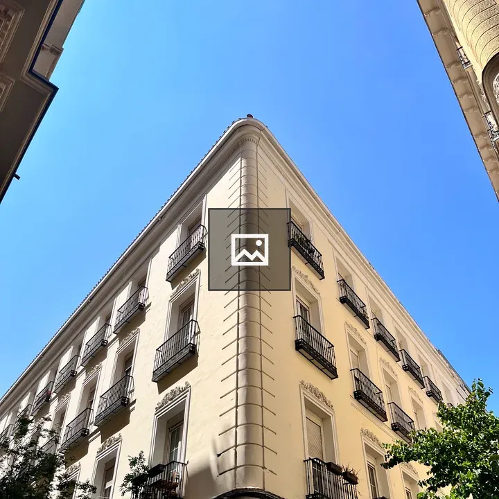 Corner beige building with balconies