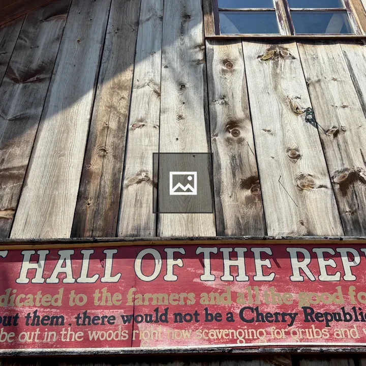 Side of a barn with rustic sign