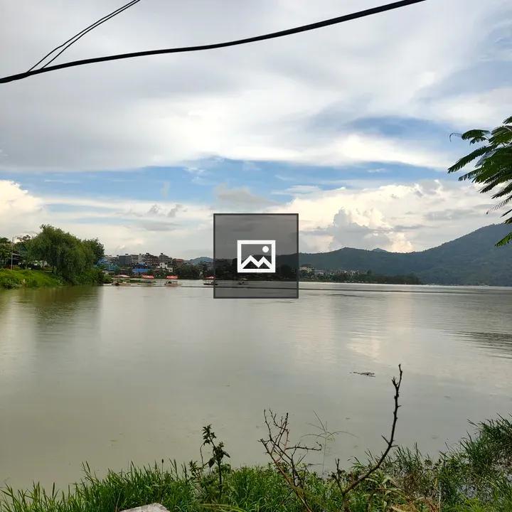 Lakeside Scene with Cloudy Sky