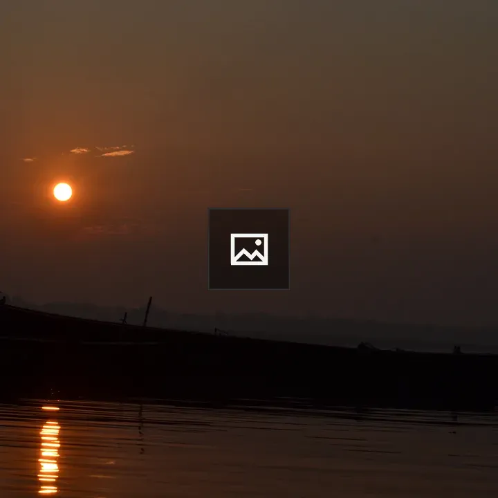 Sunset over the Ganga River with a Boat
