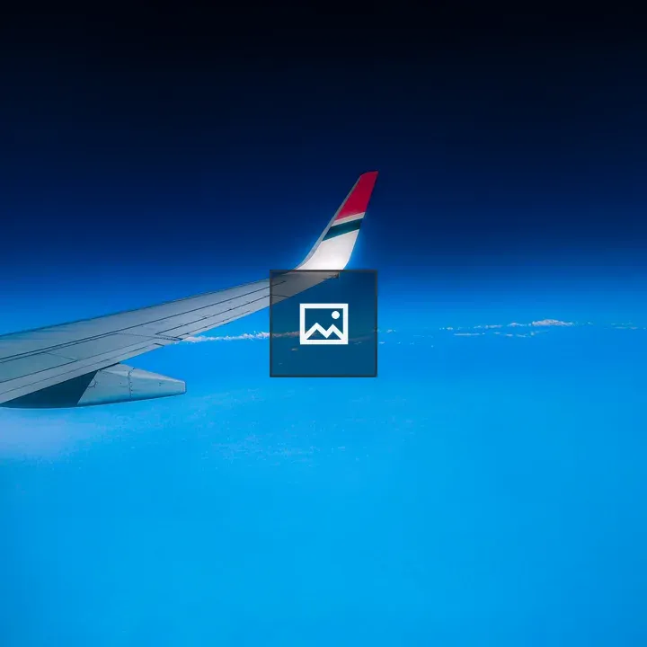 Wing of aeroplane against blue sky