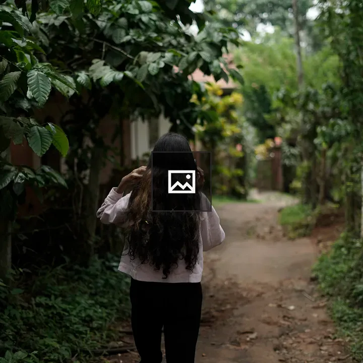 Girl walking on leafy path