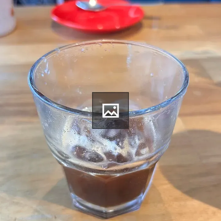 Glass of coffee on wooden table
