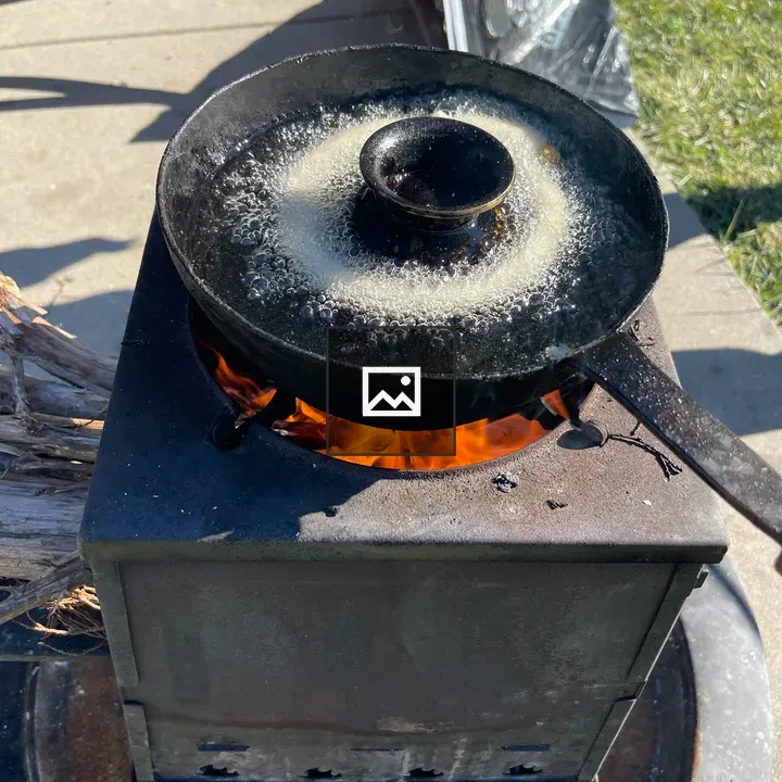 Sel roti frying on stove