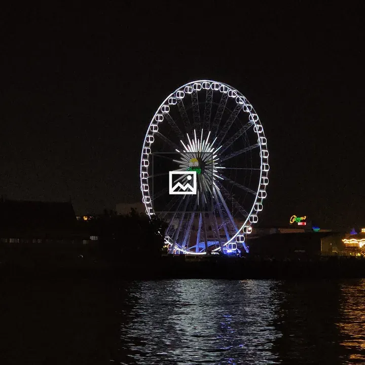 Illuminated Ferris Wheel by the River
