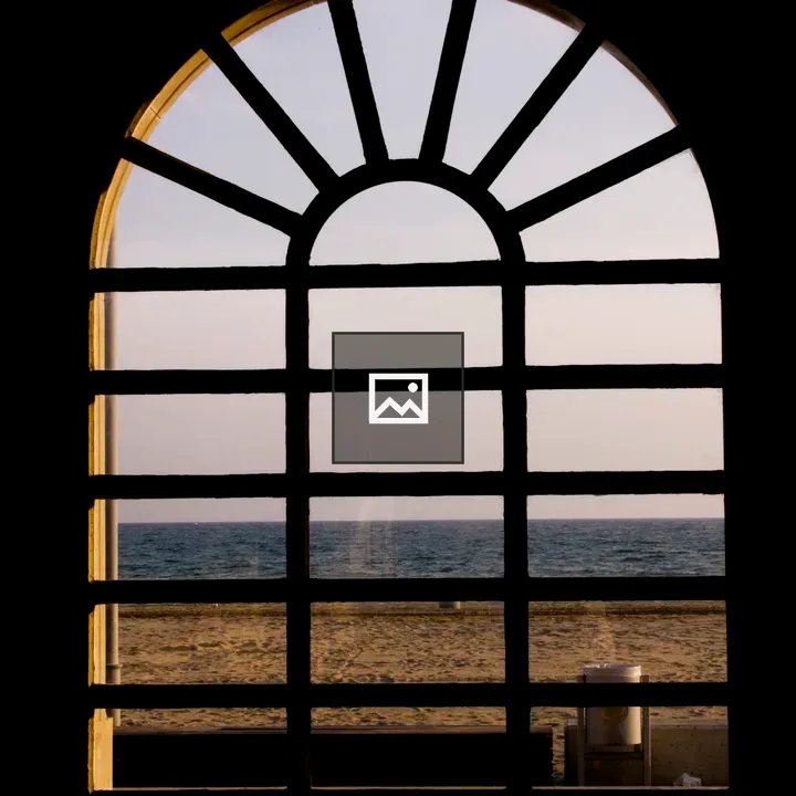 Arched window view of Mediterranean beach