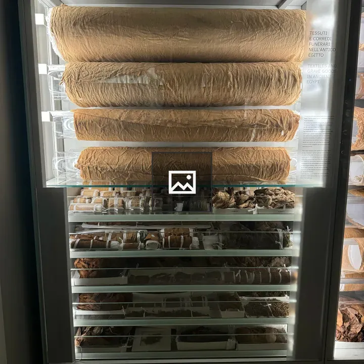 Sealed display case with grave goods textiles