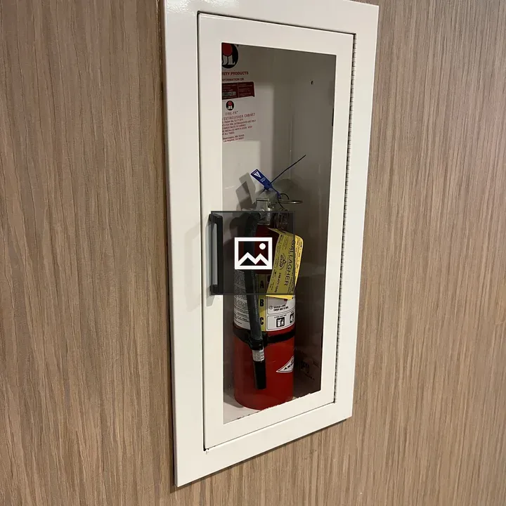 Handheld fire extinguisher in alcove